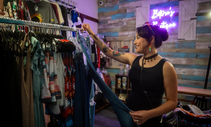 woman looking at clothes at a boutique