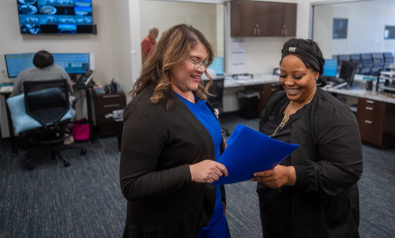 two healthcare workers looking at a file