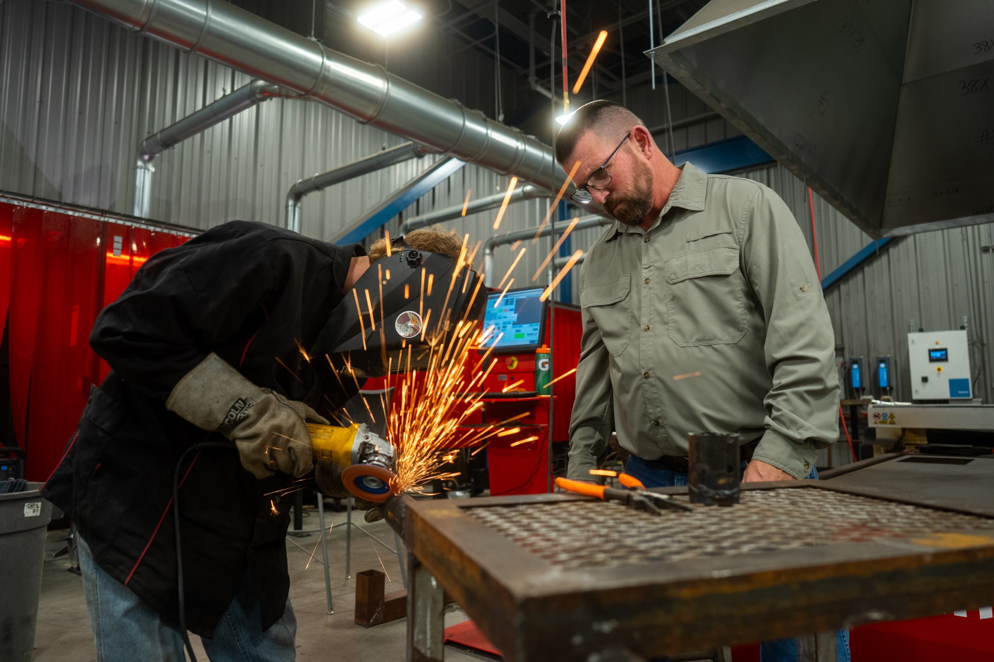 two men welding metal