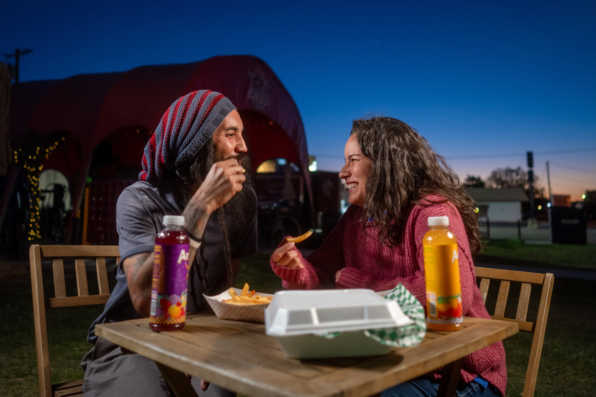 couple enjoying food from a food truck